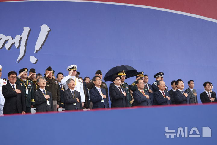 [성남=뉴시스] 조수정 기자 = 우원식(앞줄 왼쪽부터) 국회의장, 조희대 대법원장, 이종석 헌법재판소장, 노태악 중앙선거관리위원장, 국민의힘 한동훈 대표, 주호영 국회부의장, 국민의힘 추경호 원내대표, 더불어민주당 박찬대 원내대표 등이 1일 성남 서울공항에서 열린 건군 76주년 국군의날 기념식에서 국기에 경례하고 있다. 2024.10.01. chocrystal@newsis.com