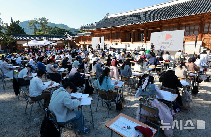 [서울=뉴시스] 고범준 기자 = 4일 오후 서울 종로구 경복궁 흥복전에서 열린 '전 국민 받아쓰기 대회'에서 참가자들이 받아쓰기를 하고 있다.   이번 대회는 578돌 한글날 계기로 우리 말글에 대한 관심을 높이고 정확하고 품격 있는 우리말 사용을 장려하기 위해 기획됐다. 2024.10.04. bjko@newsis.com