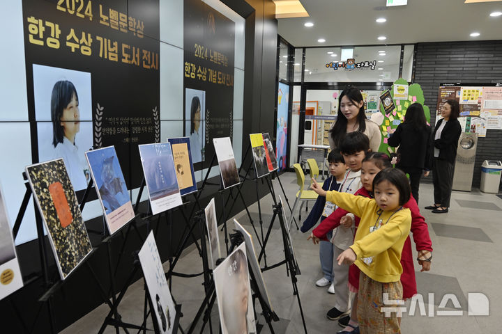 [광주=뉴시스] 박기웅 기자 = 14일 오전 광주 북구 중흥동 중흥도서관이 마련한 '2024 노벨문학상 한강 수상 기념 도서 전시'에서 아이들이 한강 작가의 도서 표지를 살펴보고 있다. 2024.10.14. pboxer@newsis.com