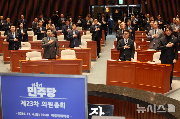 [서울=뉴시스] 조성우 기자 =  박찬대 더불어민주당 원내대표 등 의원들이 4일 오전 서울 여의도 국회에서 열린 의원총회에서 국기에 대한 경례를 하고 있다. 2024.11.04. xconfind@newsis.com