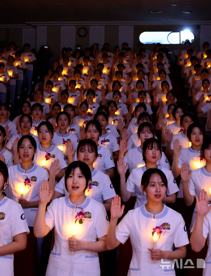 [인천=뉴시스] 전진환 기자 = 8일 오후 인천 연수구 가천대학교 메디컬캠퍼스에서 열린 제77회 나이팅게일 선서식에서 임상실습을 앞둔 간호대학 2학년 학생들이 촛불을 들고 선서를 하고 있다.  2024.11.08. amin2@newsis.com