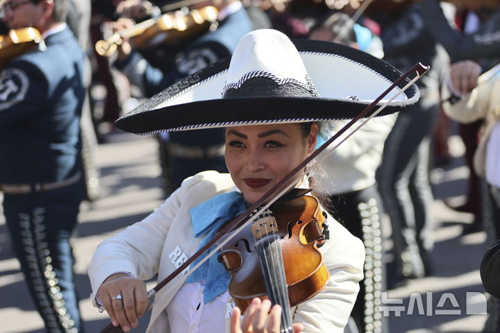 [멕시코시티=AP/뉴시스] 10일(현지시각) 멕시코 수도 멕시코시티의 소칼로 광장에서 '최다 마리아치 연주' 기네스 기록 도전자들이 악기를 연주하고 있다. '마리아치'는 멕시코의 전통 음악이자 밴드 형태를 의미하며 기타, 바이올린, 트럼펫 등의 악기로 구성된다. 이날 1천 명이 넘는 연주자가 모여 기존 700명의 기록을 깼지만, 기네스 측은 아직 공식 신기록 여부는 공표하지 않은 것으로 알려졌다. 2024.11.11.