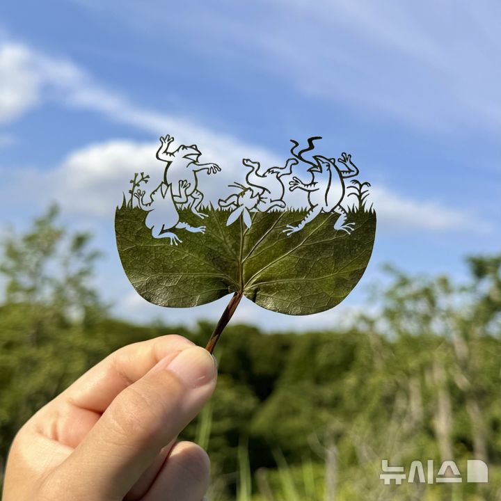 This undated photo provided by Japanese leaf-cutting artist, who goes by the name Lito, shows his work titled: "Choju Giga/Scrolls of Frolicking Animals." (Lito via AP)