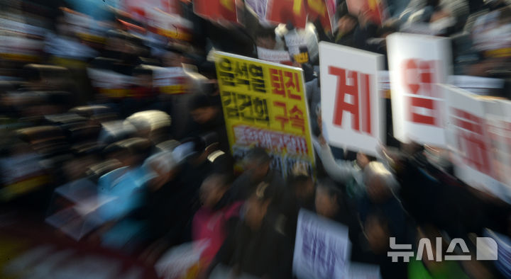 [전주=뉴시스] 김얼 기자 = 윤석열퇴진전북행동본부 관계자들이 4일 전북 전주시 관통로사거리에서 '비상계엄 선포 결의대회'를 열고 구호를 외치고 있다. 2024.12.04. pmkeul@newsis.com