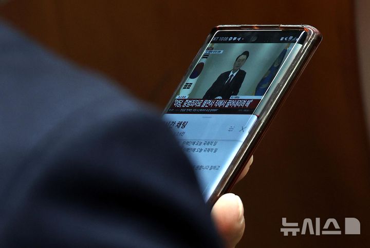 [서울=뉴시스] 조성봉 기자 = 12일 오전 서울 여의도 국회에서 열린 국민의힘 원내대표 선출을 위한 의원총회에서 한 의원이 윤석열 대통령의 대국민담화 방송을 보고 있다. 2024.12.12. suncho21@newsis.com