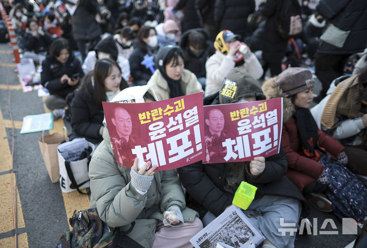 [서울=뉴시스] 정병혁 기자 = 14일 서울 영등포구 국회 앞에서 열린 '내란수괴 윤석열 즉각탄핵' 범국민 촛불대행진에 참가한 시민들이 피켓을 들고 있다. 2024.12.14. jhope@newsis.com