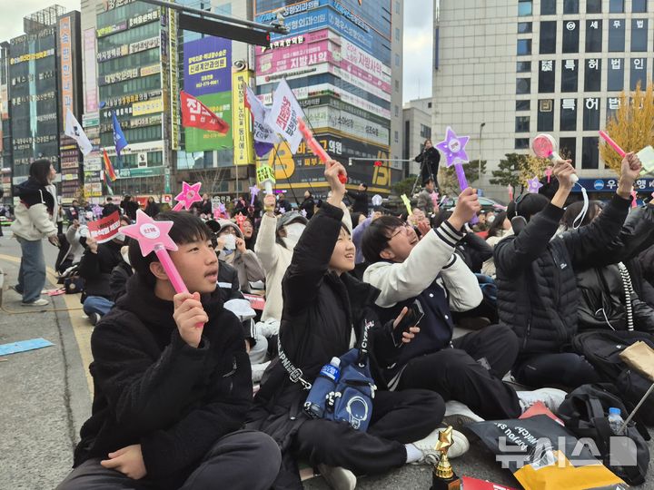 [울산=뉴시스] 구미현 기자 = 15일 울산 남구 롯데백화점 울산점 정문 앞 광장에서 열린 '울산시민촛불대회'에 참가한 청소년들이 응원봉을 흔들며 윤석열 대통령 퇴진을 외치고 있다. 2024.12.15. gorgeouskoo@newsis.com