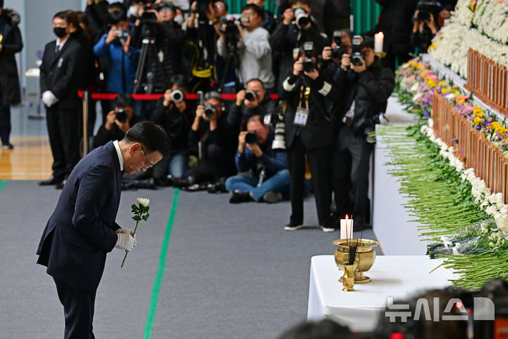 [무안=뉴시스] 이영주 기자 = 최상목 대통령 권한대행 부총리 겸 기획재정부 장관이 30일 오후 전남 무안종합스포츠파크에 차려진 제주항공 여객기 사고 희생자 합동분향소에서 헌화하고 있다.(공동취재) 2024.12.30. photo@newsis.com