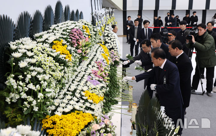 [대구=뉴시스] 이무열 기자 = 홍준표 대구시장이 31일 대구 달서구 두류공원 안병근올림픽유도기념관에 마련된 제주항공 여객기 사고 희생자 합동분향소에서 헌화하고 있다. 2024.12.31. lmy@newsis.com