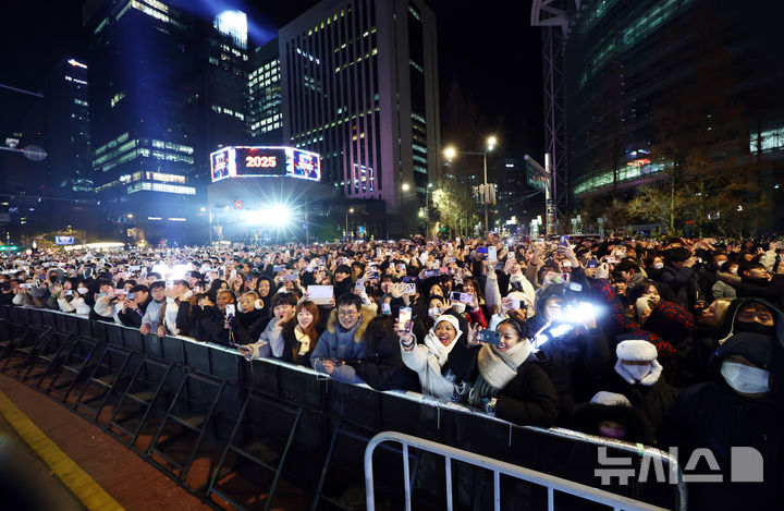 [서울=뉴시스] 전신 기자 = 2025년 을사년 새해 첫날인 1일 서울 종로구 보신각에서 열린 제야의 종 타종행사에서 시민들이 타종 장면을 바라보고 있다. 2025.01.01. photo1006@newsis.com