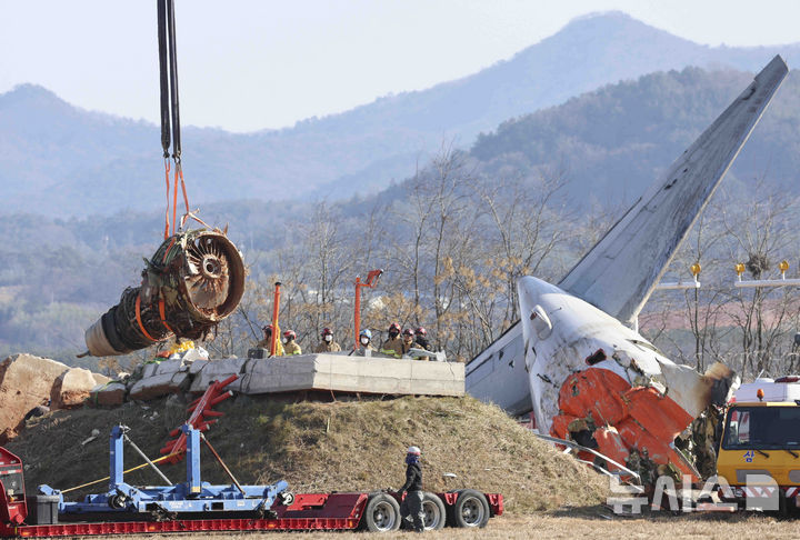 [무안=뉴시스] 김근수 기자 = 3일 전남 무안군 무안국제공항 제주항공 여객기 참사 현장에서 소방당국 관계자들이 크레인을 이용해 여객기 엔진부분을 들어올리고 있다. 2025.01.03. ks@newsis.com