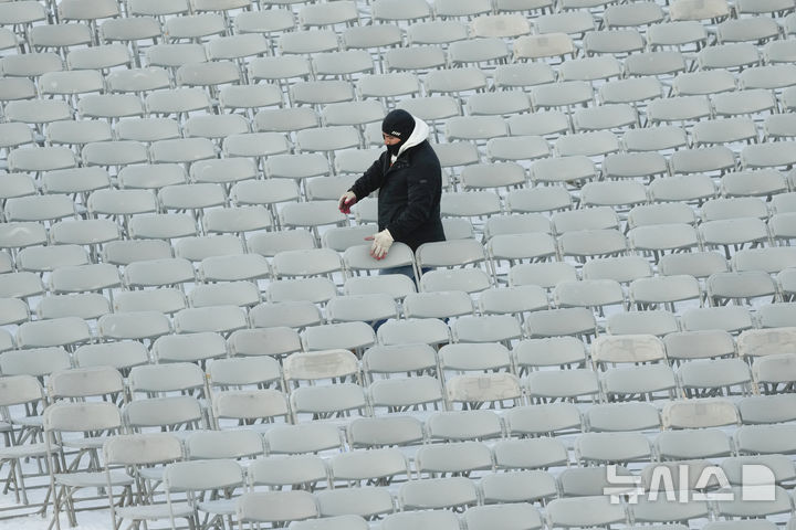 [워싱턴=AP/뉴시스] 12일(현지 시간) 미국 워싱턴 의회 의사당 서쪽에서 한 근로자가 도널드 트럼프 대통령 당선인의 취임식을 앞두고 의자를 정리하고 있다. 트럼프 당선인은 오는 20일 제47대 대통령으로 취임한다. 2025.01.13.