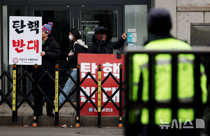 [서울=뉴시스] 김진아 기자 = 20일 오전 서울 종로구 헌법재판소 앞에서 탄핵을 반대하는 지지자들이 손팻말을 들고 있다. 2025.01.20. bluesoda@newsis.com
