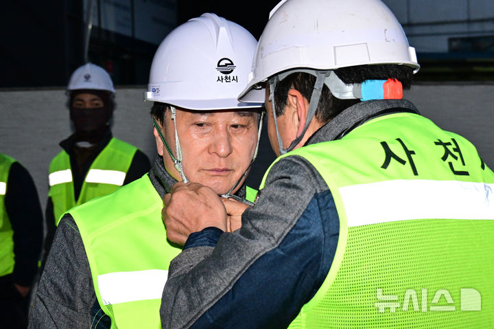 [사천=뉴시스] 차용현 기자 = 22일 오전 경남 사천시 소속 한 환경미화원이 쓰레기 수거 봉사에 나선 박동식 시장에게 안전모를 씌워주고 있다. 2025.01.22. con@newsis.com