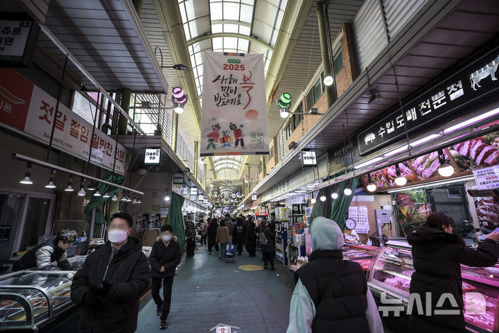 [서울=뉴시스] 정병혁 기자 = 설을 앞둔 지난달 23일 서울 마포구 망원시장을 찾은 시민들이 장을 보고 있다. 2025.02.03. jhope@newsis.com