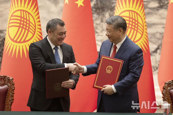 [베이징=AP/뉴시스] 시진핑(오른쪽) 중국 국가 주석과 사디르 자파로프 키르기스스탄 대통령이 5일(현지 시간) 중국 베이징 인민대회당에서 서명한 협정서를 교환하며 악수하고 있다. 자파로프 대통령은 시 주석의 초청으로 중국을 방문했다. 2025.02.05.