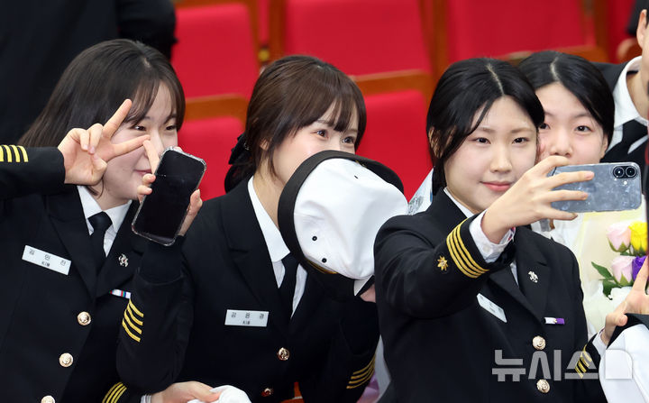 [부산=뉴시스] 하경민 기자 = 7일 오전 부산 영도구 한국해양대학교 대강당에서 열린 '해사대학 2024학년도 전기 학위수여식'에 참석한 졸업생들이 기념사진을 찍고 있다. 한국해양대는 상선 등에 승선해 병역의무를 이행하는 승선근무예비역 병역제도 때문에 매년 해사대학과 일반대학으로 구분해 학위수여식을 따로 진행하고 있다. 2025.02.07. yulnetphoto@newsis.com