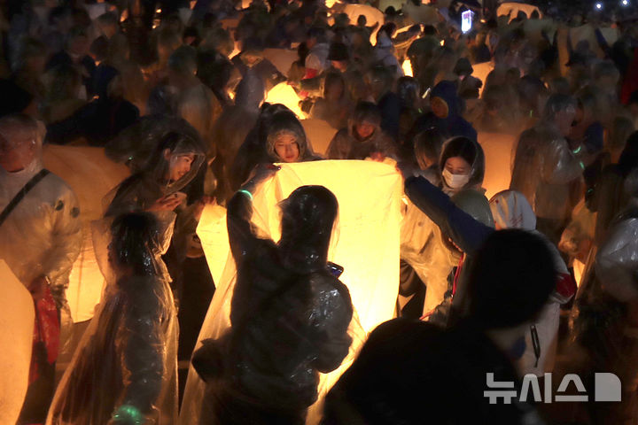 [신베이=AP/뉴시스] 12일(현지 시간) 대만 신베이 핑시에서 전통 천등(풍등) 축제가 열려 사람들이 행운과 번영을 기원하는 풍등 띄울 준비를 하고 있다. 2025.02.13.