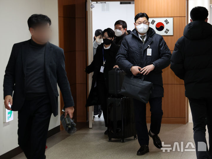 [서울=뉴시스] 배훈식 기자 = 경찰청 국가수사본부 비상계엄 특별수사단이 이상민 전 행정안전부 장관 집무실과 자택에 대한 압수수색에 들어간 18일 오후 서울 종로구 정부서울청사 행안부 사무실에서 수사관들이 압수품을 가져 나오고 있다. 2025.02.18. dahora83@newsis.com
