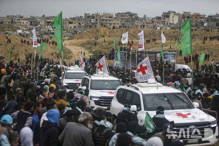 [가자지구=AP/뉴시스] 20일(현지 시간) 가자지구 남부 칸 유니스에서 하마스에 억류됐다가 숨진 이스라엘 인질 4명의 시신이 이스라엘로 송환되고 있다. 하마스는 앞서 이스라엘 인질 시리 비바스와 두 아들 아리엘·크피르 비바스 그리고 오데드 리프시츠 등 4명의 시신을 돌려보냈다. 2025.02.21.