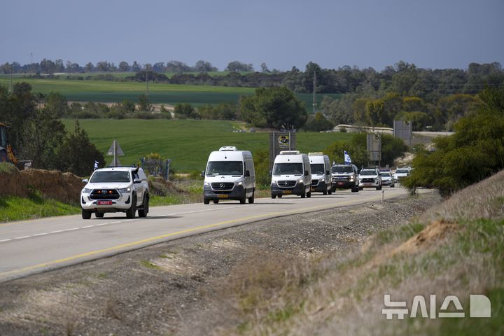 [키부츠=AP/뉴시스] 20일(현지 시간) 하마스에 억류됐다가 숨진 이스라엘 인질 4명의 시신을 실은 호송차량이 이스라엘 남부 키부츠를 지나고 있다. 하마스는 앞서 이스라엘 인질 시리 비바스와 두 아들 아리엘·크피르 비바스 그리고 오데드 리프시츠 등 4명의 시신을 돌려보냈다. 2025.02.21.