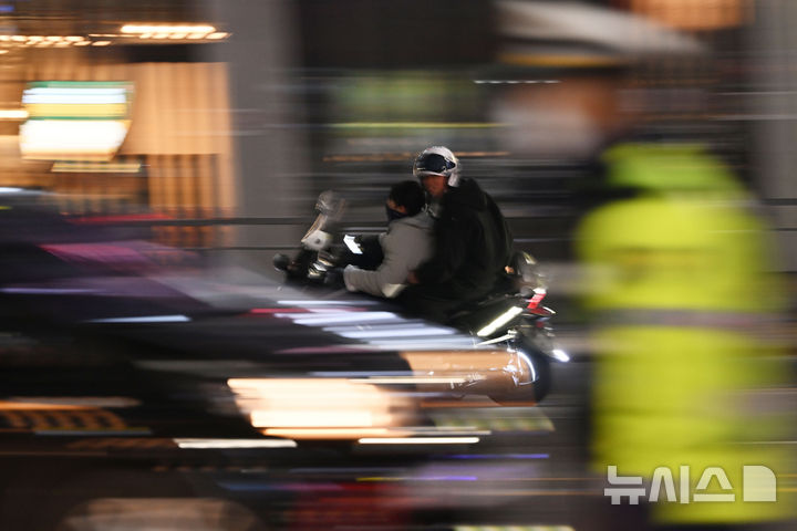 [광주=뉴시스] 이영주 기자 = 지난달 28일 오후 광주 광산구 수완지구 한 사거리 주변 도로에서 차량 번호판을 뗀 폭주 이륜차량이 경찰의 음주단속 현장을 지나치고 있다. 2025.03.01. leeyj2578@newsis.com