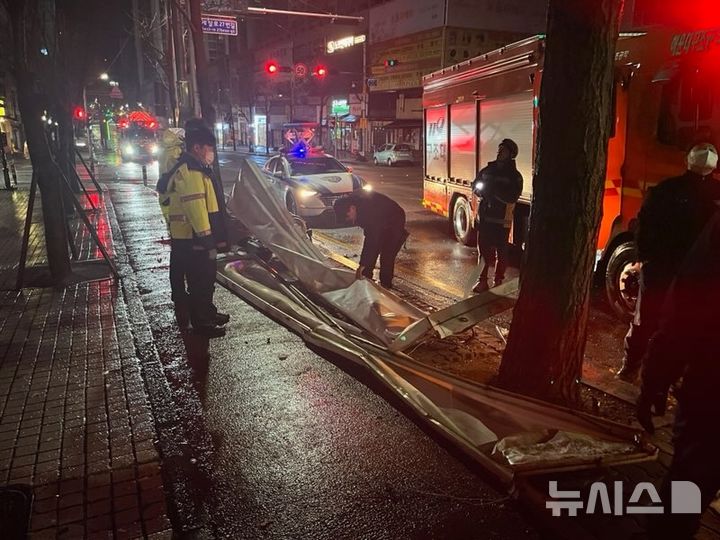 [부산=뉴시스] 강풍특보가 내려진 3일 오전 부산 해운대구의 한 도로에 간판이 떨어졌다는 신고가 접수돼 소방이 안전조치에 나섰다. (사진=부산소방재난본부 제공) 2025.03.03. photo@newsis.com *재판매 및 DB 금지