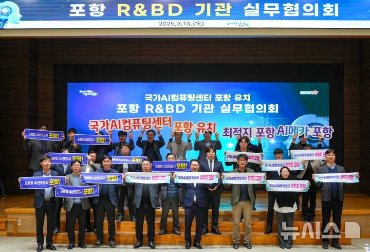 [포항=뉴시스] 송종욱 기자 = 송종욱 기자 = 포항시는 13일 시청 대회의실에서 연구개발과제 사업화(R&BD) 기관 실무협의회를 열고, '국가인공지능(AI)컴퓨팅센터' 포항 유치에 역량을 결집하기로 했다. 사진은 21개 R&BD 기관 실무자들이 '국가AI컴퓨팅센터' 포항 유치 퍼포먼스 모습. (사진=포항시 제공) 2025.03.13. photo@newsis.com