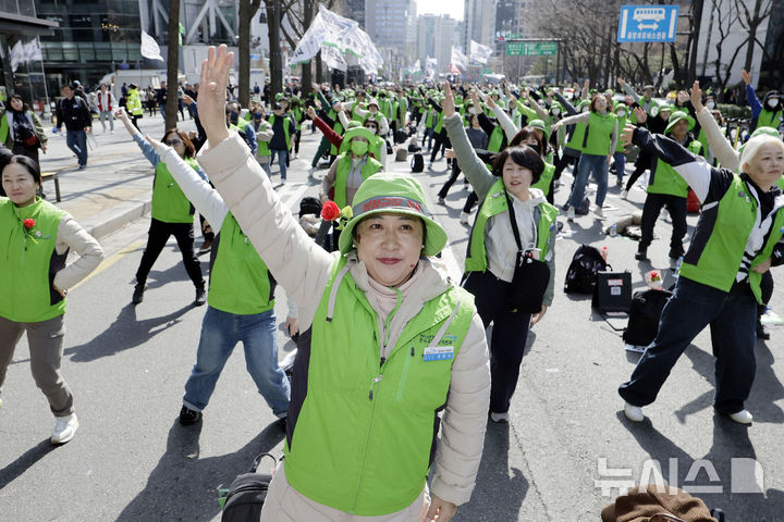 [서울=뉴시스] 최동준 기자 = 민주노총 공공운수노조 전국교육공무직본부가 15일 서울 종각역 인근에서 결의대회를 열고 학교공공성 강화, 비정규직 차별 철폐 등을 촉구하는 플래시몹을 하고 있다. 2025.03.15. photocdj@newsis.com