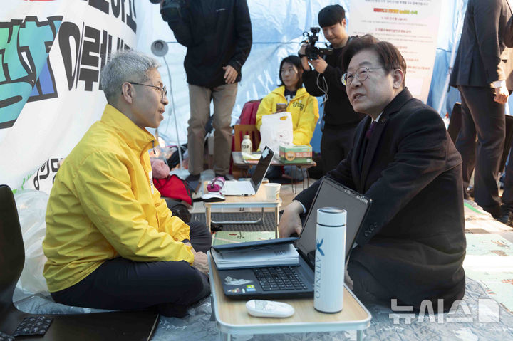 [서울=뉴시스] 추상철 기자 = 이재명 더불어민주당 대표가 21일 오후 서울 종로구 광화문 인근 정의당 농성텐트를 찾아 권영국 정의당 대표와 대화하고 있다. (공동취재) 2025.03.21. photo@newsis.com