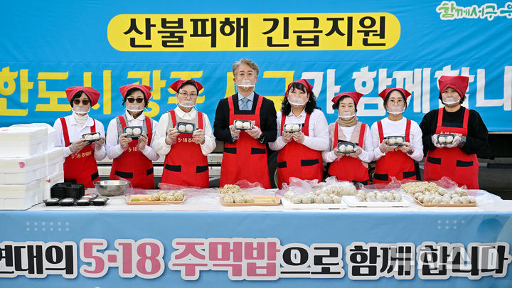 [광주=뉴시스] 이영주 기자 =김이강(가운데) 광주 서구청장과 '양동 장금이' 회원들이 31일 서구청 교통과 주차장에서 산불 피해를 입은 경북 영덕군 주민들에게 전달할 나눔과 연대의 상징인 5·18주먹밥을 만들고 있다. (사진 = 광주 서구 제공) 2025.03.31. photo@newsis.com