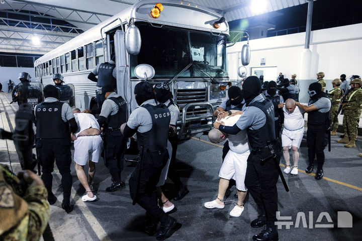 [테콜루카=AP/뉴시스] 지난달 31일(현지 시간) 엘살바도르 테콜루카 '테러범 수용소'(CECOT·세코트)에서 교도관들이 미국으로부터 추방된 이주자들을 압송하고 있다. 미국이 베네수엘라 갱단 조직원으로 지목해 추방한 이들 가운데 실제 조직원인 사람은 거의 없는 것으로 전해진다. 2025.4.16.