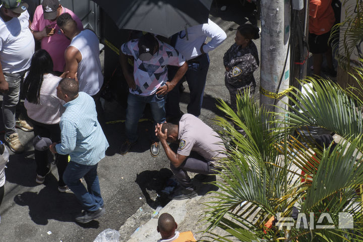 A police officer reacts during the search for survivors at the Jet Set nightclub after its roof collapsed during a concert in Santo Domingo, Dominican Republic, Tuesday, April 8, 2025. (AP Photo/Ricardo Hernandez)