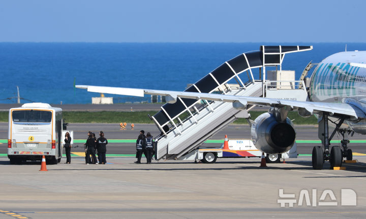 [제주=뉴시스] 우장호 기자 = 15일 오전 8시15분께 제주공항 활주로에서 승객이 비상문을 열어 비상탈출용 슬라이드가 펼쳐저 항공기가 이륙을 포기하는 사고가 발생했다. 비상탈출 슬라이드가 개방되자 기동 불능상태가 된 항공기는 멈춰 섰고, 한국공항공사는 견인차로 이 항공기를 주기장으로 옮겼다. 이날 오전 주기장으로 옮겨진 에어서울 RS902편 모습. 2025.04.15. woo1223@newsis.com
