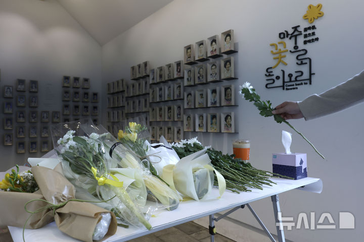 [서울=뉴시스] 최동준 기자 = 세월호 참사 11주기인 16일 서울 중구 서울시의회 앞 세월호 기억공간에서 한 시민이 헌화하고 있다. 2025.04.16. photocdj@newsis.com