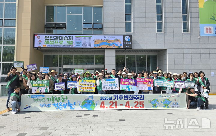 [안산=뉴시스] 제55회 지구의 날을 기념해 시민들이 안산 갈대습지 일대에서 기후변화주간 캠페인을 진행하며 기념촬영을 하고 있다. (사진=안산시 제공) 2025.04.25. photo@newsis.com