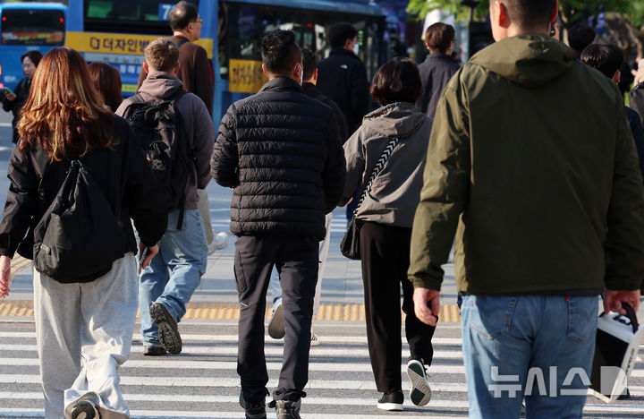 [서울=뉴시스] 이영환 기자 = 아침 기온이 떨어지며 비교적 쌀쌀한 날씨를 보인 25일 오전 서울 종로구 광화문네거리에서 외투를 걸친 시민들이 이동하고 있다. 2025.04.25. 20hwan@newsis.com