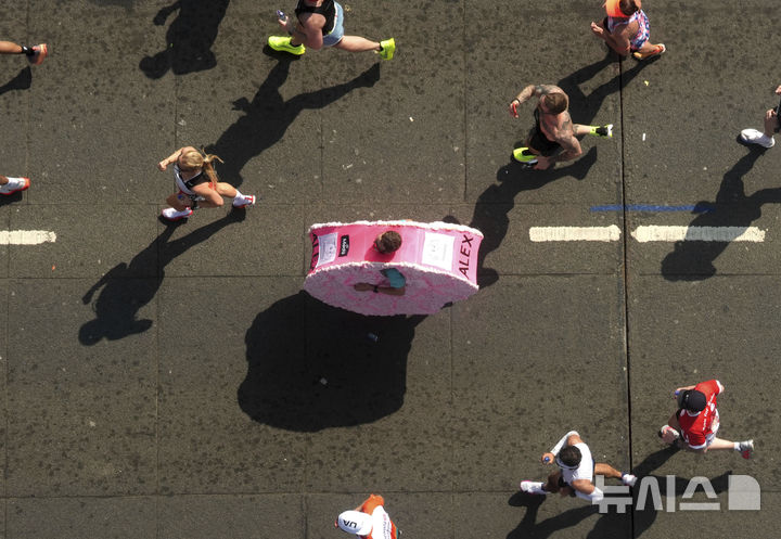 [런던=AP/뉴시스] 27일(현지 시간) 영국 런던에서 열린 2025 런던 마라톤에 참가한 참가자들이 결승선을 향해 달리고 있다. 2025.04.28.