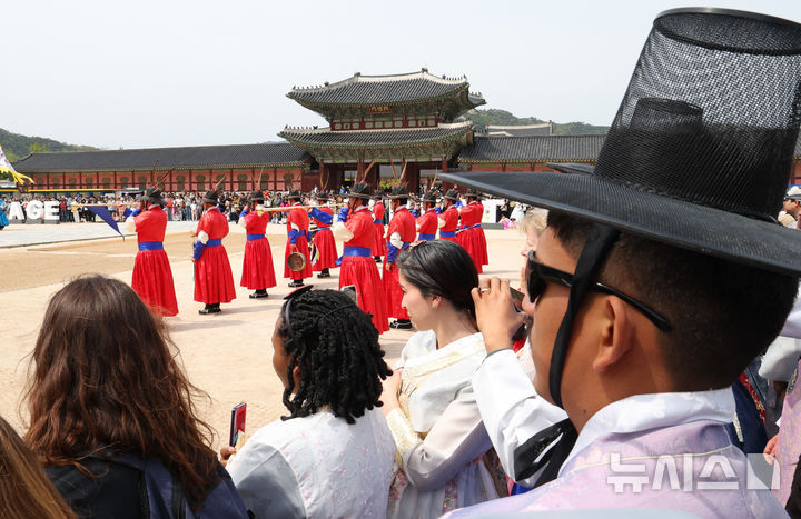 [서울=뉴시스] 최진석 기자 = 궁중문화축전 2일차인 27일 오후 서울 종로구 경복궁에서 열린 수문장 교대의식을 외국인들이 관람하고 있다. ‘궁중문화축전’은 대한민국을 대표하는 문화유산이며 조선과 대한제국의 역사를 품고 있는 경복궁, 창덕궁, 창경궁, 덕수궁, 경희궁 등 서울 소재 5개의 궁궐과 종묘에서 펼쳐지는 문화유산 축제이다. 2025.04.27. myjs@newsis.com