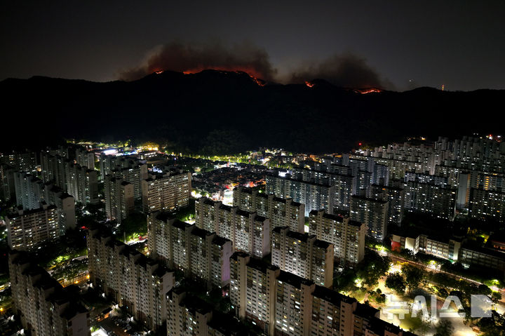 [대구=뉴시스] 이무열 기자 = 28일 밤 대구 북구 노곡동과 조야동 인근 산을 따라 불이 주택가 방향으로 확산하고 있다. 이날 오후 2시1 분쯤 대구 북구 노곡동 함지산에서 발생한 산불로 인해 민가 피해를 막기 위해 소방청은 국가소방동원령을 발령했다. 2025.04.28. lmy@newsis.com
