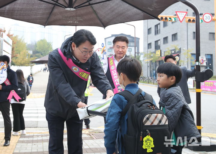 [화성=뉴시스]정명근 화성시장이 학교 앞에서 어린이 안전을 위해 교통봉사를 하고 있다.(사진=화성시 제공)2025.05.02.photo@newsis.com