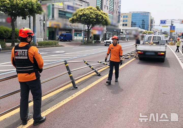 [제주=뉴시스] 강풍주의보가 내려진 3일 오전 제주시 이도2동에서 도로 중앙분리대가 쓰러져 소방당국이 안전조치에 나서고 있다. (사진=제주소방안전본부 제공) 2025.05.03. photo@newsis.com 