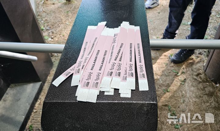 [제주=뉴시스] 임재영 기자 = 4일 오전 한라산국립공원 관음사탐방로 입구에서 탐방객에게 나눠주고 있는 '띠지'. 2025.05.04. ijy788@newsis.com