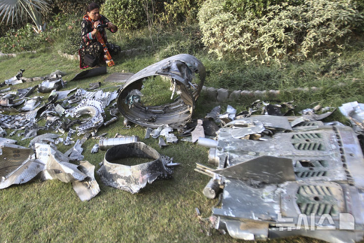 [바하왈푸르=AP/뉴시스] 한 파키스탄 기자가 7일(현지 시간) 펀자브주 바하왈푸르 인근, 인도의 미사일 공격으로 파손된 사원 건물 부지에서 미사일 파편을 촬영하고 있다. 2025.05.08.