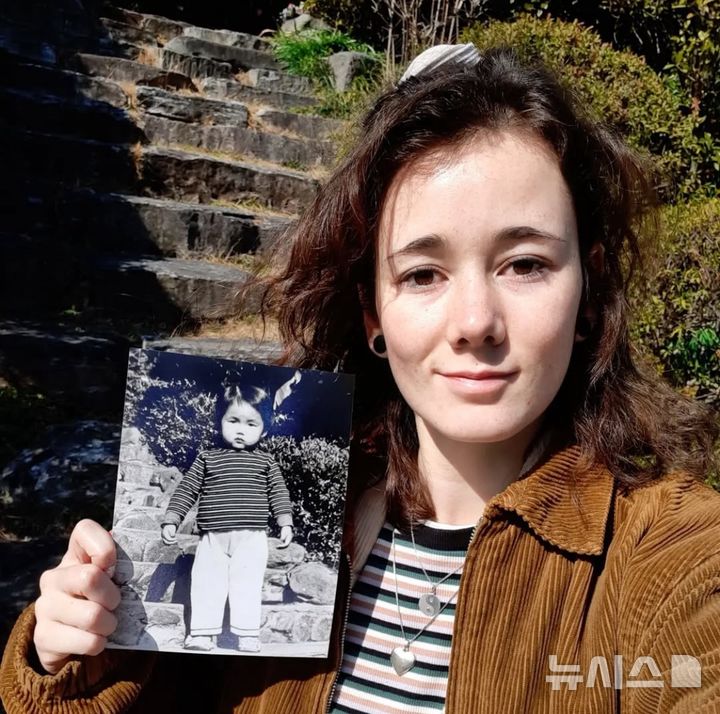 [서울=뉴시스] 해외입양인 2세인 마릿(30)이 광주시 남구 소재 한 사회복지시설에서 어머니의 사진을 들고 있다. 해당 시설은 1996년까지 보육원으로 운영됐다. (사진=마릿 제공) 2025.05.11. photo@newsis.com 