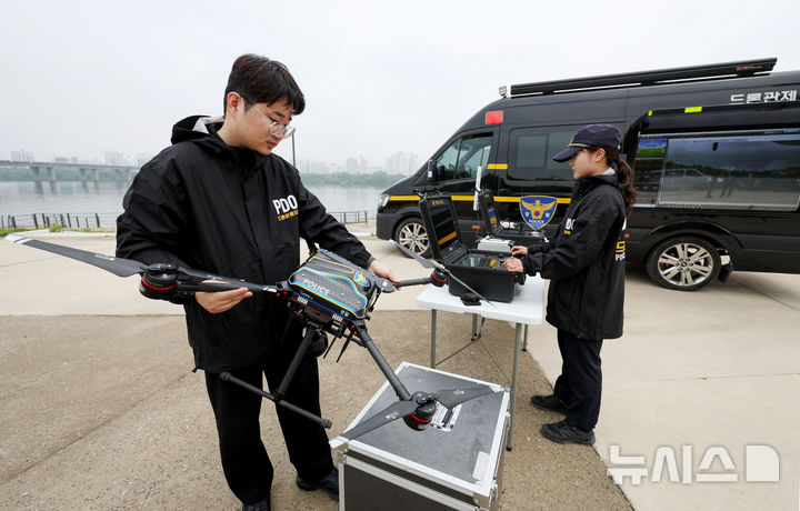 [서울=뉴시스] 김진아 기자 = 11일 서울 여의도 한강공원에서 열린 'K-스마트 순찰' 시범에서 서울경찰청 기동순찰대 등 대원들이 드론 순찰 시연을 하고 있다.&nbsp;&nbsp; 서울경찰청은 '특별범죄예방활동강화기간'의 일환으로 오는 6월 30일까지 많은 시민들이 이용하는 여의도권 일대에 드론·웨어러블 로봇·전기자전거 등 첨단 장비를 활용한 'K-스마트 순찰'을 시범운영한다. 2025.05.11. bluesoda@newsis.com