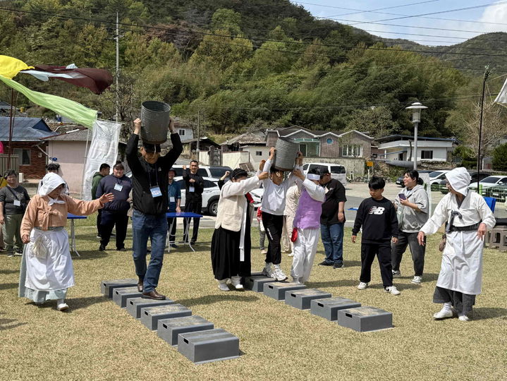 [밀양=뉴시스] 밀양법흥상원놀이 전수교육관의 민속 체험활동(물동이 나르기). (사진=밀양시 제공) 2025.05.15. photo@newsis.com *재판매 및 DB 금지