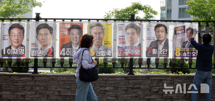 [인천=뉴시스] 전진환 기자 = 15일 오후 인천 동구의 한 아파트 담장에서 송림 3,5동 행정복지센터 관계자가 제21대 대통령선거 선거벽보를 부착하고 있다. 2025.05.15. amin2@newsis.com