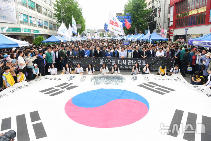 [광주=뉴시스] 이영주 기자 = 5·18 민주화운동 45주년을 하루 앞둔 17일 오후 광주 동구 금남로 일대에서 열린 전야행사에서 광주역과 전남대, 조선대 등지에서 출발한 시민들로 이뤄진 '민주평화대행진단'이 행사장으로 행진하고 있다. leeyj2578@newsis.com