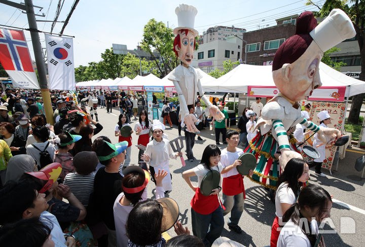 [서울=뉴시스] 김금보 기자 = 18일 서울 성북구 성북동 주민센터 건너편 성북로 일대에서 열린 '제 17회 성북세계음식축제 누리마실'에서 서커스 퍼포먼스 퍼레이드 공연이 펼쳐지고 있다. 2025.05.18. kgb@newsis.com